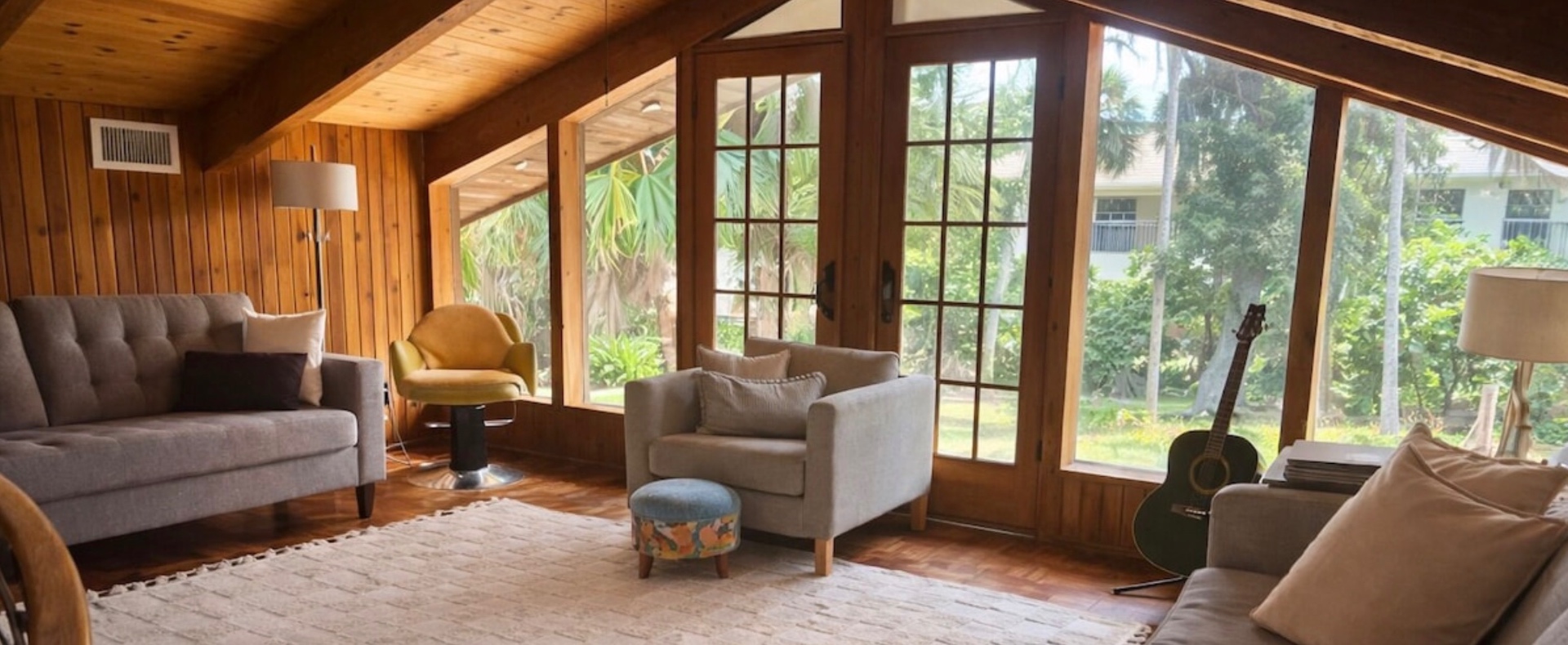 Florida Room — Bright lounge with French doors and tropical views