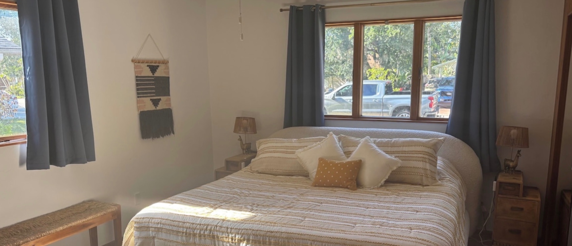 Queen Guest Room — Bright corner room with blackout curtains and garden views